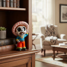 The Talavera Hub hand-painted skeleton man figurine with sombrero, blue shirt, orange pants, and mustache. Day of the Dead decor.
