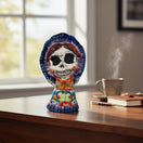 The Talavera Hub Day of the Dead skeleton woman figurine in traditional dress with floral designs and bonnet.