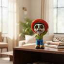 The Talavera Hub hand-painted ceramic skeleton man figurine with red sombrero, blue pants, green shirt, and mustache.