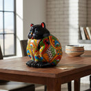 The Talavera Hub handmade black ceramic fat cat planter with colorful floral Talavera detailing. Ideal for plants or decor.