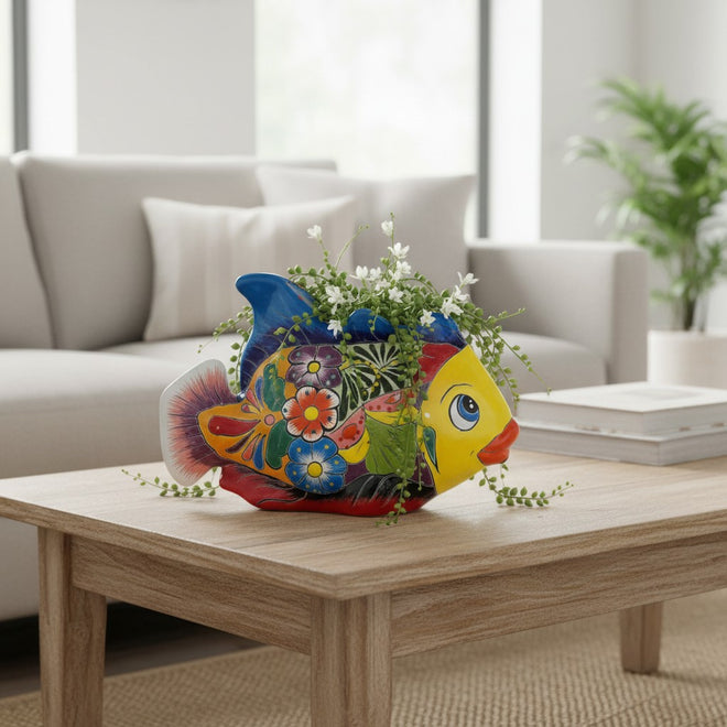 The Talavera Hub hand-painted Talavera fish planter in ceramic. Features a yellow face, blue fins, and floral motifs. 10.5" long.
