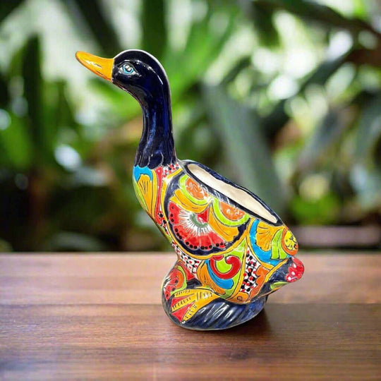The Talavera Hub hand-painted ceramic duck planter with multicolor floral designs and a glossy finish.