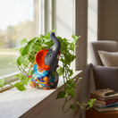 The Talavera Hub handmade gray elephant planter with colorful floral Talavera design and orange accents.