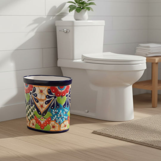The Talavera Hub handmade oval ceramic trash can with vibrant floral Talavera patterns in blue, red, orange, and green.