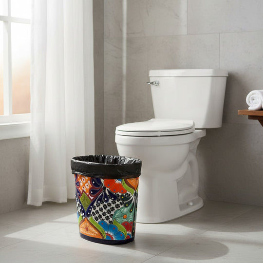The Talavera Hub handmade ceramic oval trash can with vibrant floral and geometric Talavera designs in blue, orange, green, and red.