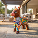 The Talavera Hub hand-painted ceramic donkey planter with floral designs in orange, yellow, green, and blue.