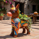 The Talavera Hub hand-painted ceramic donkey planter with floral designs in orange, yellow, green, and blue.