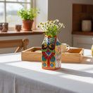 The Talavera Hub hand-painted ceramic milk carton with colorful floral and scroll designs. Decorative Mexican pottery.