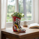 The Talavera Hub hand-painted ceramic boot planter with colorful floral and butterfly Talavera design.