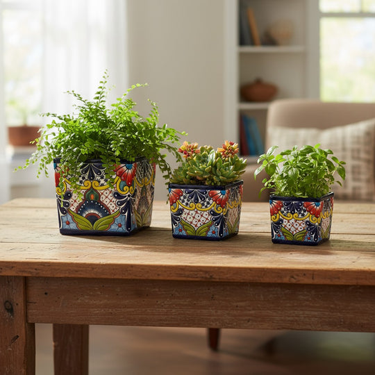 The Talavera Hub set of 3 hand-painted square Talavera planters with colorful floral designs in blue, red, yellow, and green.