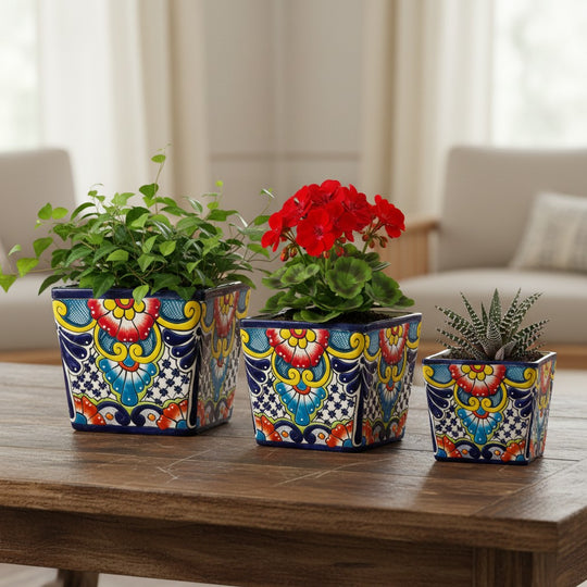 The Talavera Hub set of 3 hand-painted square Talavera planters with colorful floral designs in blue, yellow, red, and green.