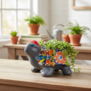 The Talavera Hub hand-painted grey ceramic turtle planter with colorful floral designs and a red shell.
