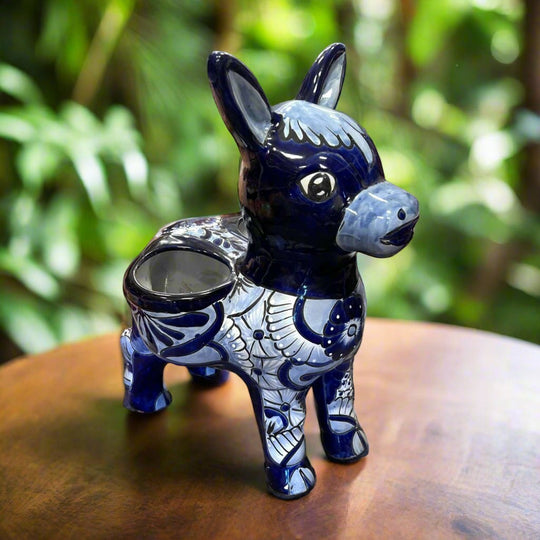 The Talavera Hub large blue and white ceramic donkey planter with hand-painted floral designs.