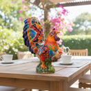 The Talavera Hub large ceramic rooster statue, hand-painted with vibrant floral details in orange, yellow, red, blue, and green.