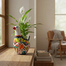 The Talavera Hub large white ceramic dove planter with colorful hand-painted floral designs and a red beak.