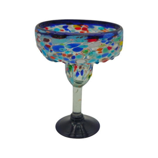 The Talavera Hub hand-blown margarita glass with blue confetti rock design and dark blue base.