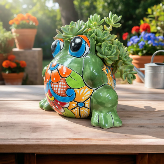 The Talavera Hub medium green Talavera frog planter, hand-painted with vibrant floral patterns in orange, blue, and red.