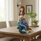 The Talavera Hub hand-painted ceramic mermaid figurine with floral tail, holding a fish. Coastal decor.