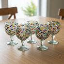 The Talavera Hub Mexican Margarita glasses with confetti pebble design. Hand-blown recycled glass, 23 oz capacity.