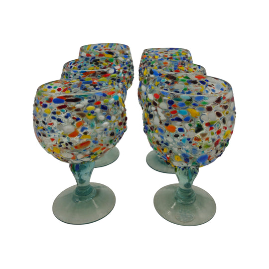 The Talavera Hub Mexican Margarita Glass with fish bowl shape and confetti pebble design in red, blue, green, yellow, and white. Hand-blown recycled glass.