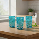 The Talavera Hub Handcrafted Mexican Teal Tumbler Glass with White Swirl Design. Lead-free glass, 12 oz capacity.