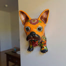 The Talavera Hub orange French Bulldog statue with colorful floral Talavera design. Handcrafted ceramic wall art.
