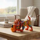 The Talavera Hub orange ceramic dog statue, hand-painted with colorful floral patterns. Lead-free glaze.