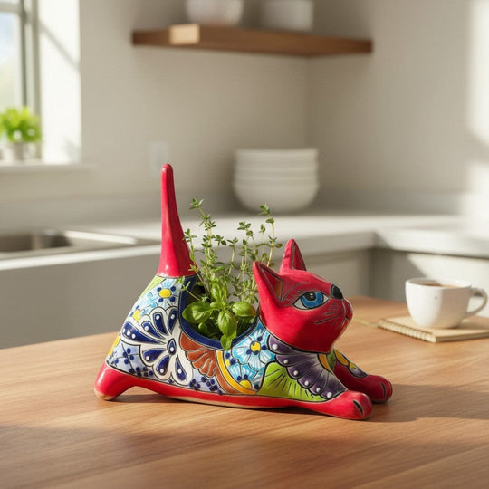 The Talavera Hub red ceramic cat planter with hand-painted floral designs in blue, yellow, and green.