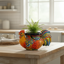 The Talavera Hub handcrafted ceramic rooster planter, hand-painted with vibrant red, blue, yellow, and green floral patterns.
