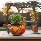 The Talavera Hub handcrafted ceramic rooster planter, hand-painted with vibrant red, yellow, blue, and green Talavera patterns.