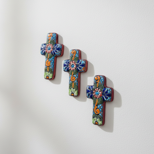 The Talavera Hub set of 3 small, hand-painted ceramic crosses with floral designs in blue, orange, and green.