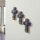 The Talavera Hub set of 3 small, handcrafted ceramic crosses with blue, orange, and green floral Talavera designs.
