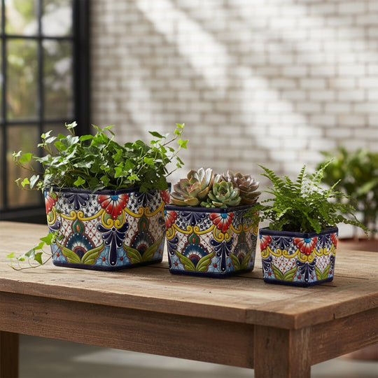The Talavera Hub set of 3 square ceramic planters, hand-painted with colorful floral Talavera designs in blue, red, yellow, and green.