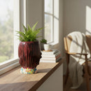 The Talavera Hub handcrafted dark red skull planter with colorful floral base, inspired by Day of the Dead.
