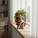 The Talavera Hub hand-painted ceramic skull planter with sunflowers and Day of the Dead face paint.