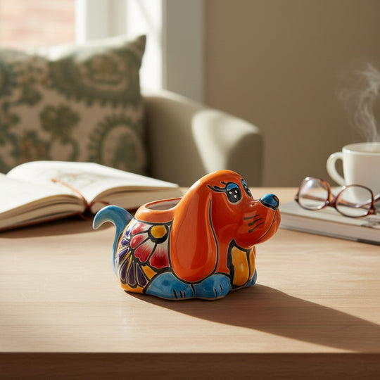 The Talavera Hub small orange dog planter with blue accents and floral design. Handmade Mexican pottery.
