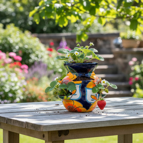The Talavera Hub ceramic strawberry planter with sunflower and lily design in orange, yellow, blue, and green.