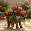 The Talavera Hub hand-painted ceramic donkey planter with colorful floral designs and two openings for plants.