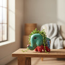 The Talavera Hub hand-painted ceramic elephant planter in teal with red, blue, and green floral details. Small size for succulents.