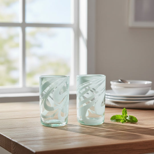 The Talavera Hub hand-blown clear glass drinking glasses with white swirl pattern, 18 oz capacity.