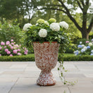 The Talavera Hub XL brown and white ceramic pedestal planter with floral motif. Handcrafted in Mexico, ideal for gardens and patios.