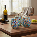 The Talavera Hub XL stemless wine glasses with colorful confetti rock design, hand-blown glass, 24 oz capacity.