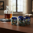 The Talavera Hub Confetti Rimmed Shot Glass with blue rim and multicolor confetti glass. Hand-blown recycled glass.