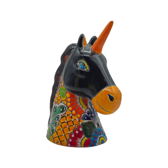 Side view of a multicolor Talavera unicorn figurine with black face and orange horn