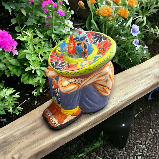 Talavera Panchito Sleeping Man Figurine | XL Hand-Painted Art — large hand-painted Mexican Talavera statue in garden setting, vibrant earthy tones